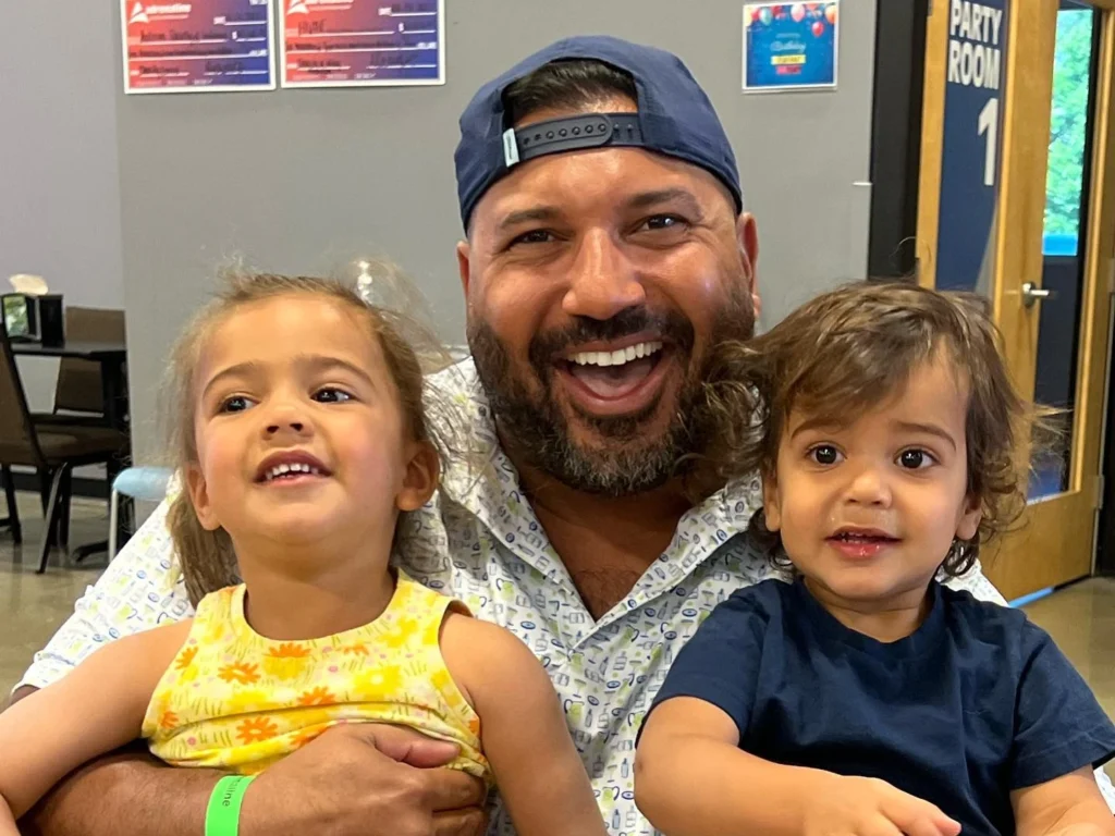 Dr. Hopkinson smiling with his kids